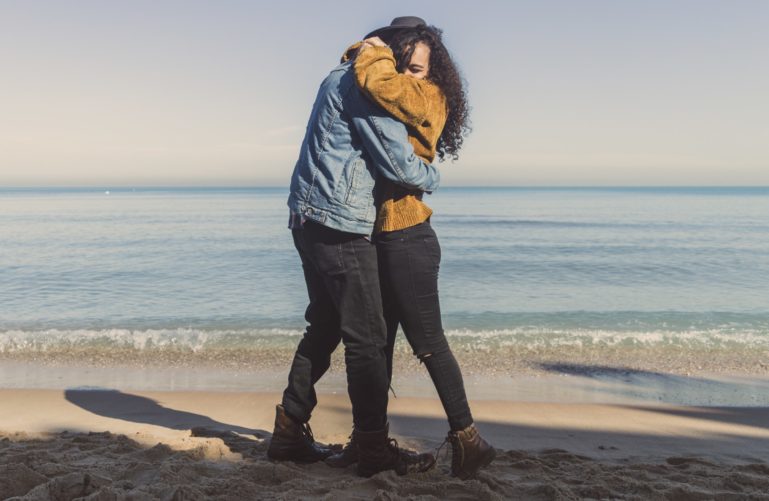 A couple hugging on a beach